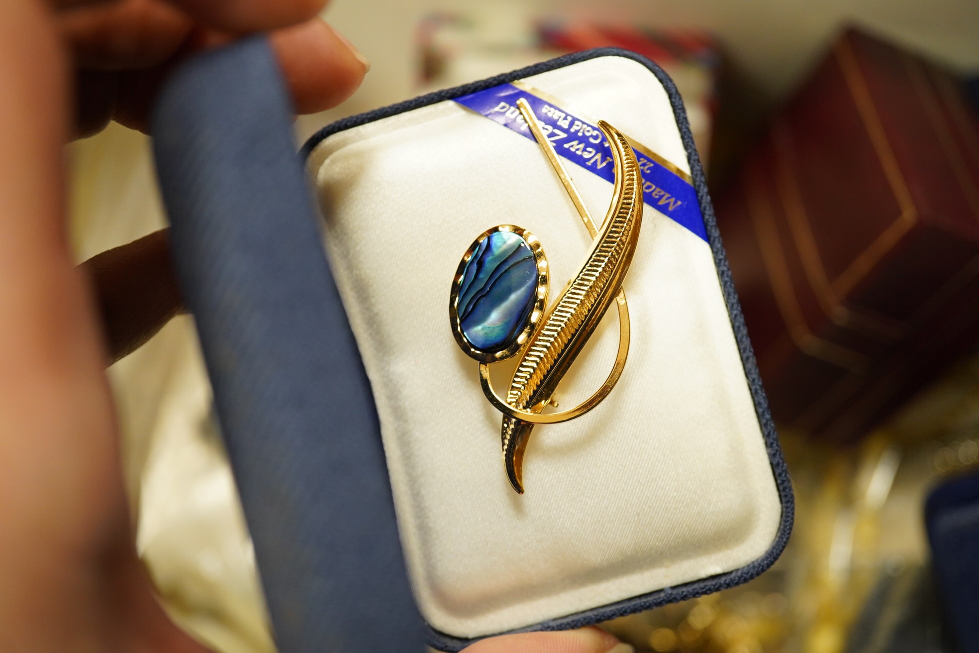 A modern 9ct gold scroll brooch, 57mm, 4.4 grams, a 9ct and gem set brooch, gross 1.4 grams, 1.3 grams, a 9ct and garnet ring, gross weight 3.7 grams, a modern lapis lazuli and cultured pearl necklace with 9ct clasp and